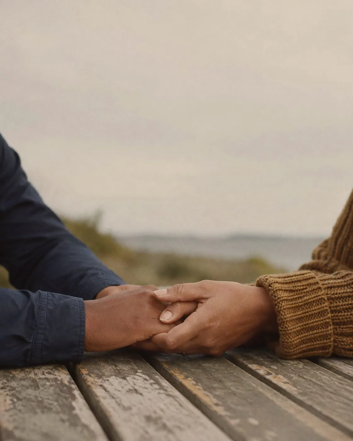 Two hands held together on a table
