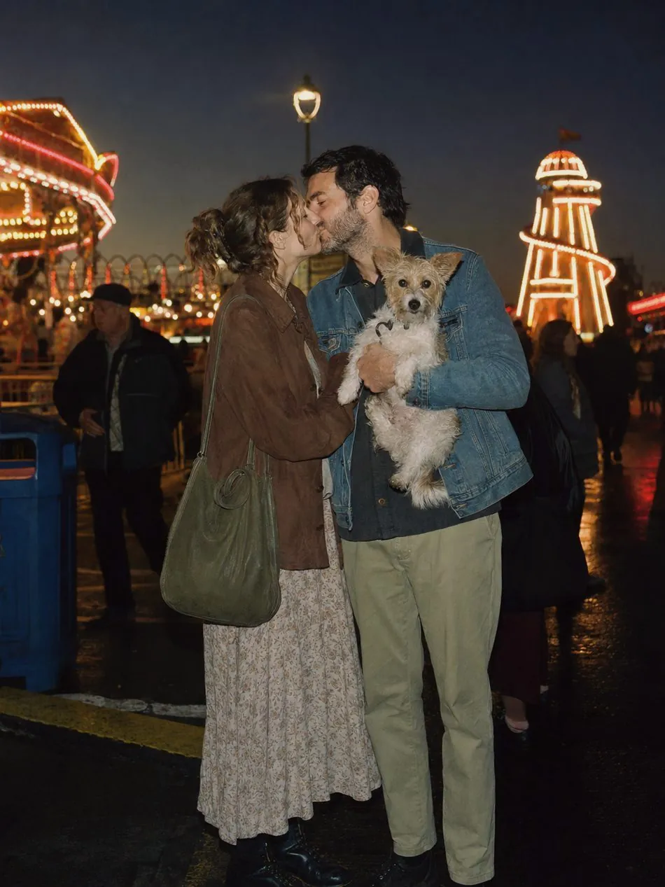 A couple with their dog under festival lights