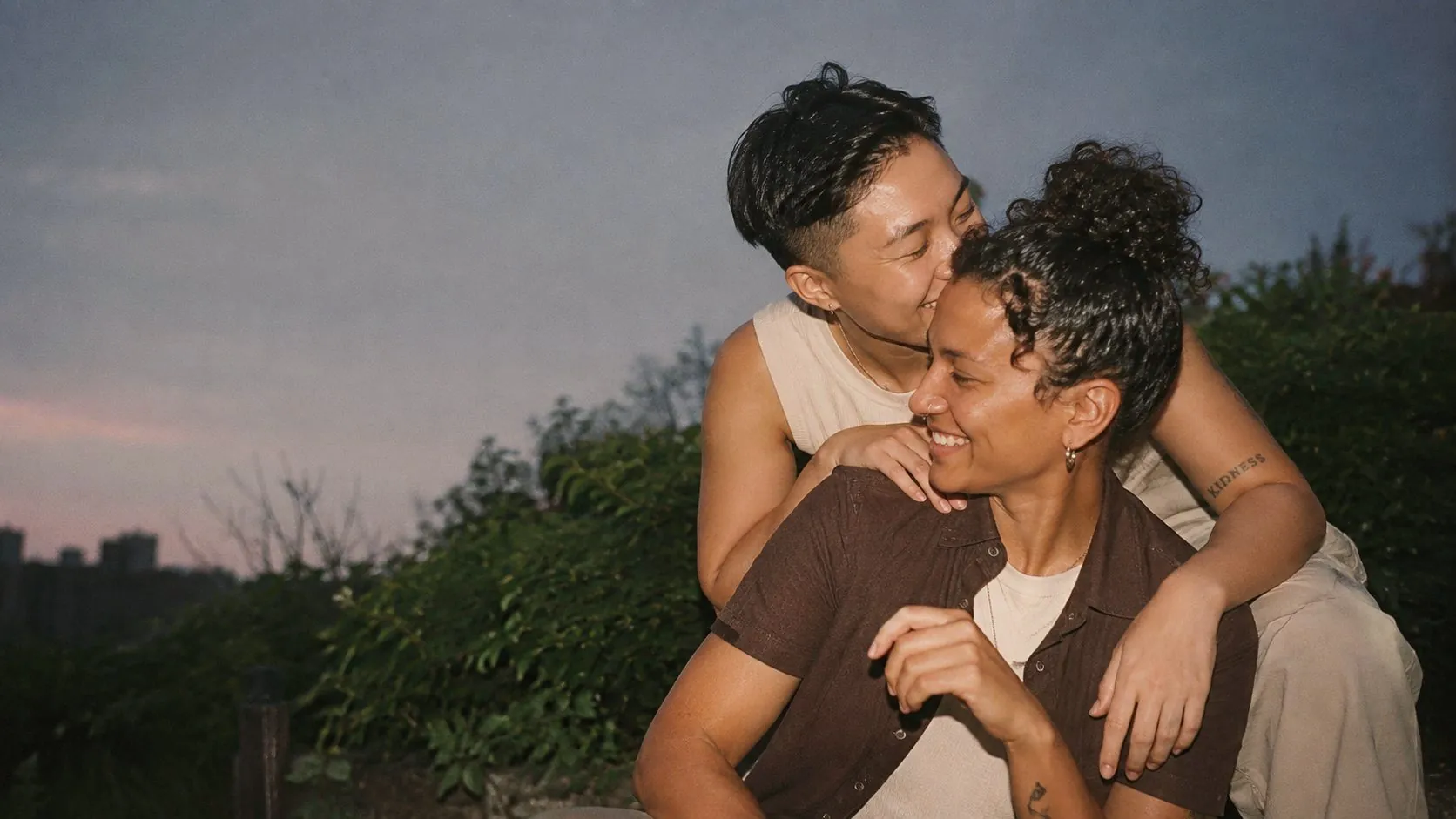 Two people holding each other close at dusk
